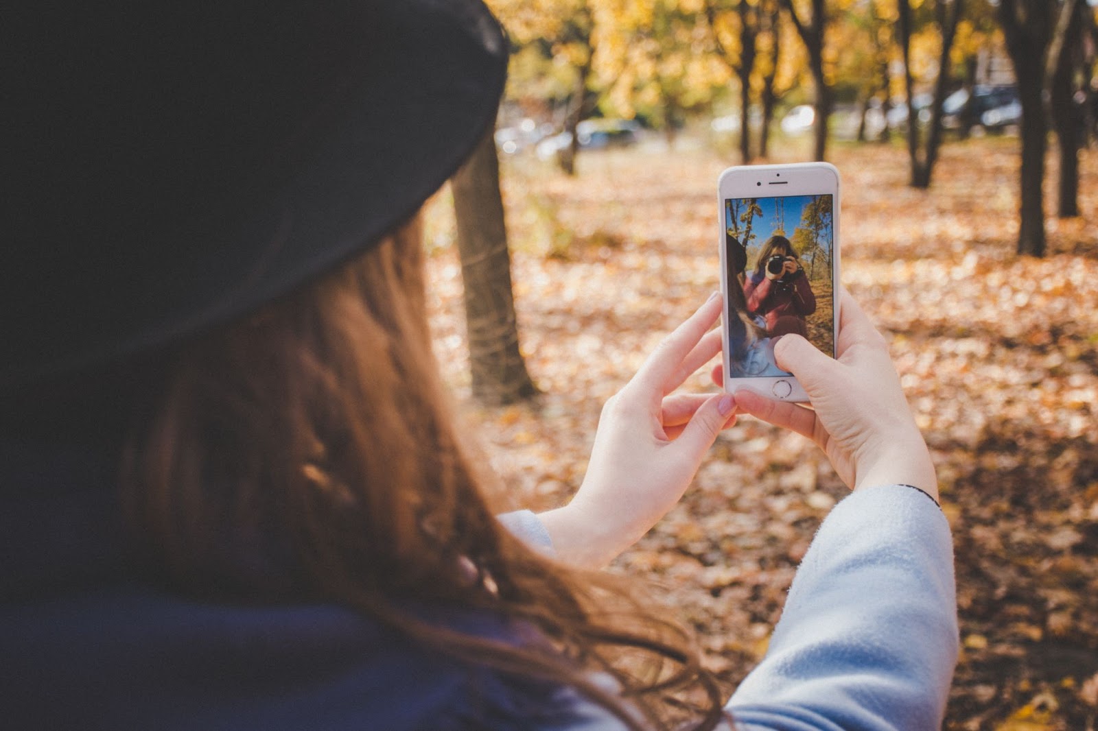 A girl taking a selfie in a park