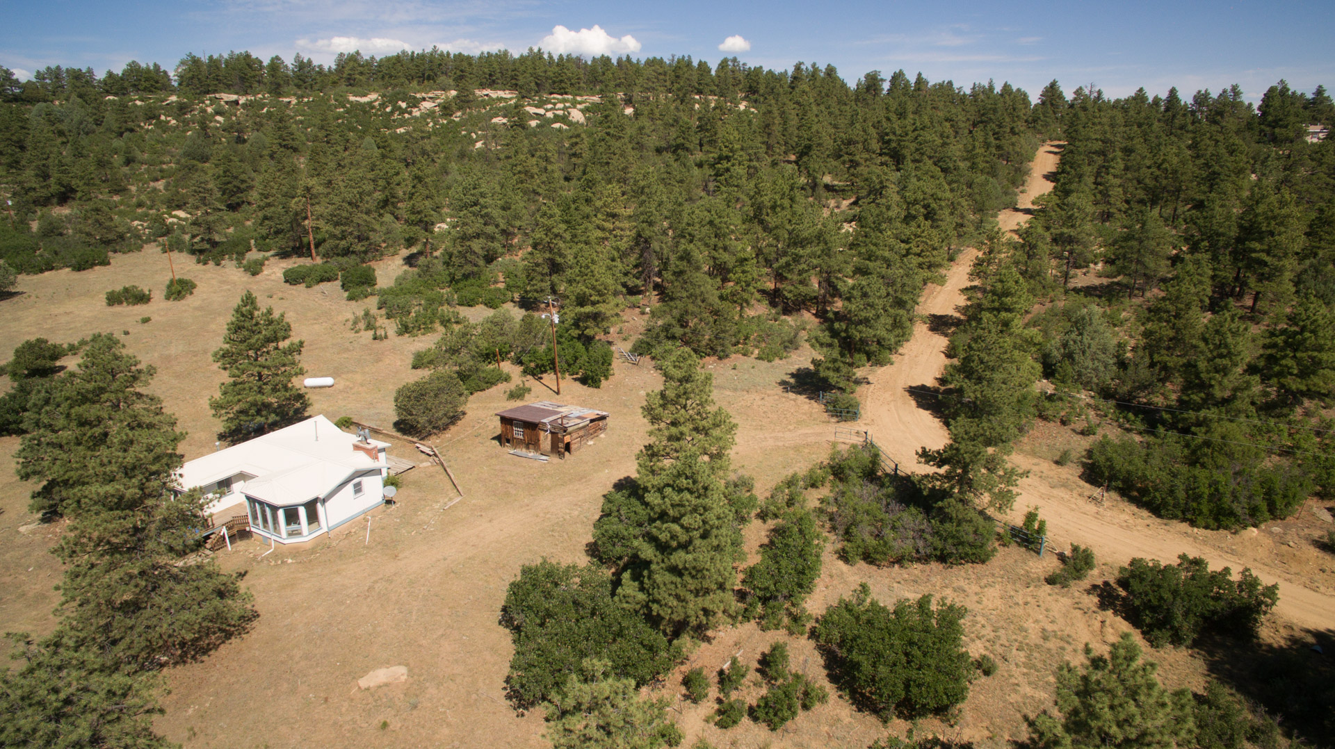 Home & cabins on a neighboring property at the base of the ridge