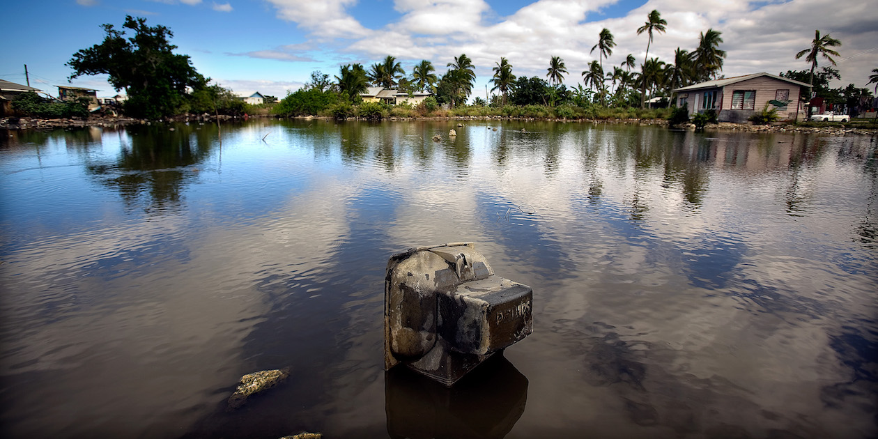 Properties built in a flood-prone area in Tonga, a low-lying island nation in the South Pacific vulnerable to rising sea levels. Photo by Asian Development Bank, licensed under (CC BY-NC-ND 2.0).