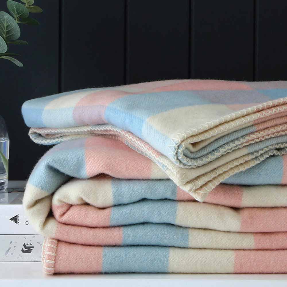 A pile of multi-coloured wool blankets