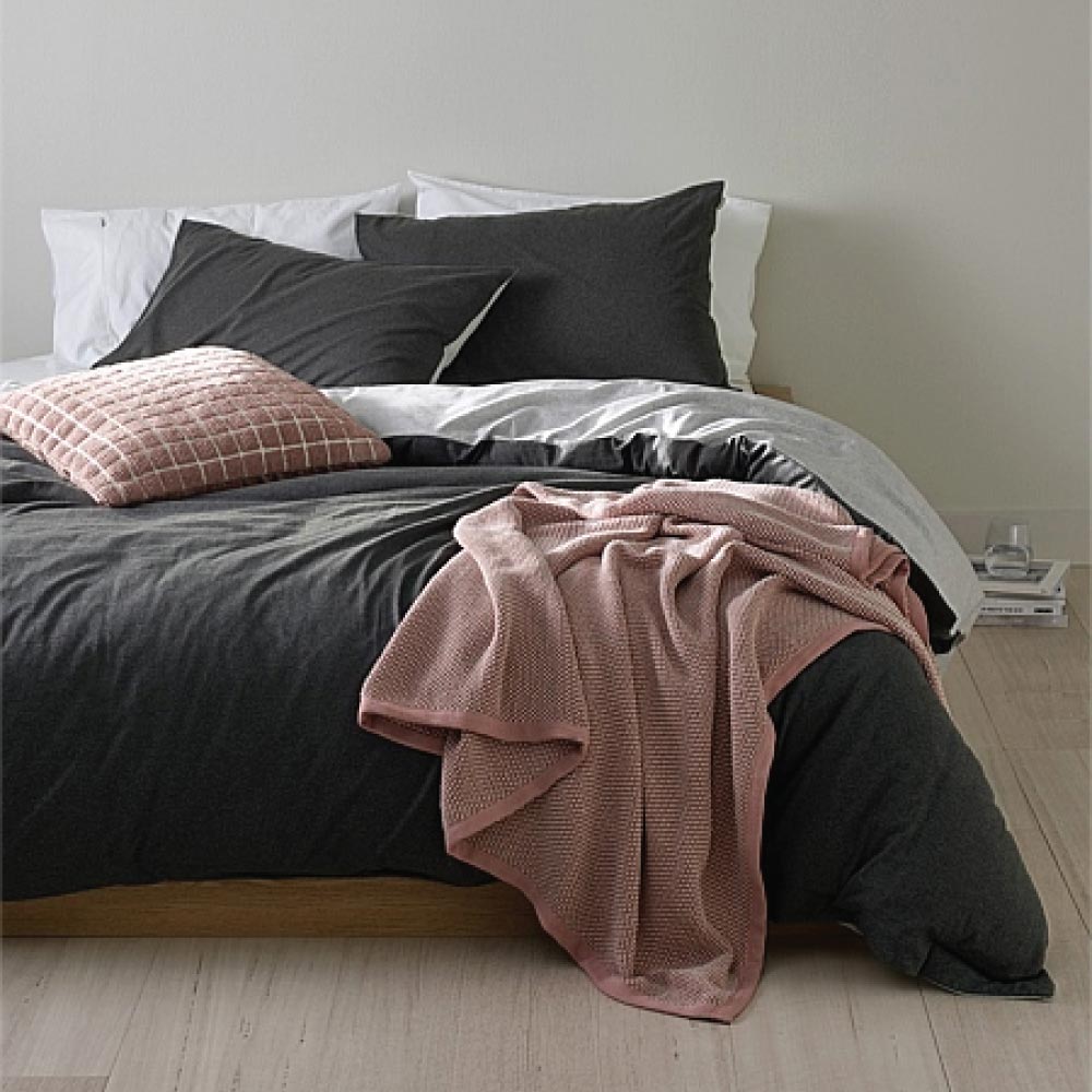 Pink Country Road throw draped over the end of a bed