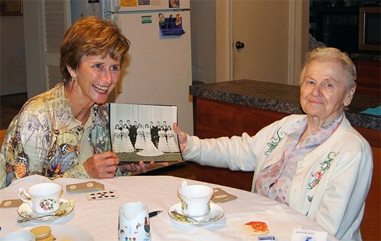 Lady looking at pictures with grandmother