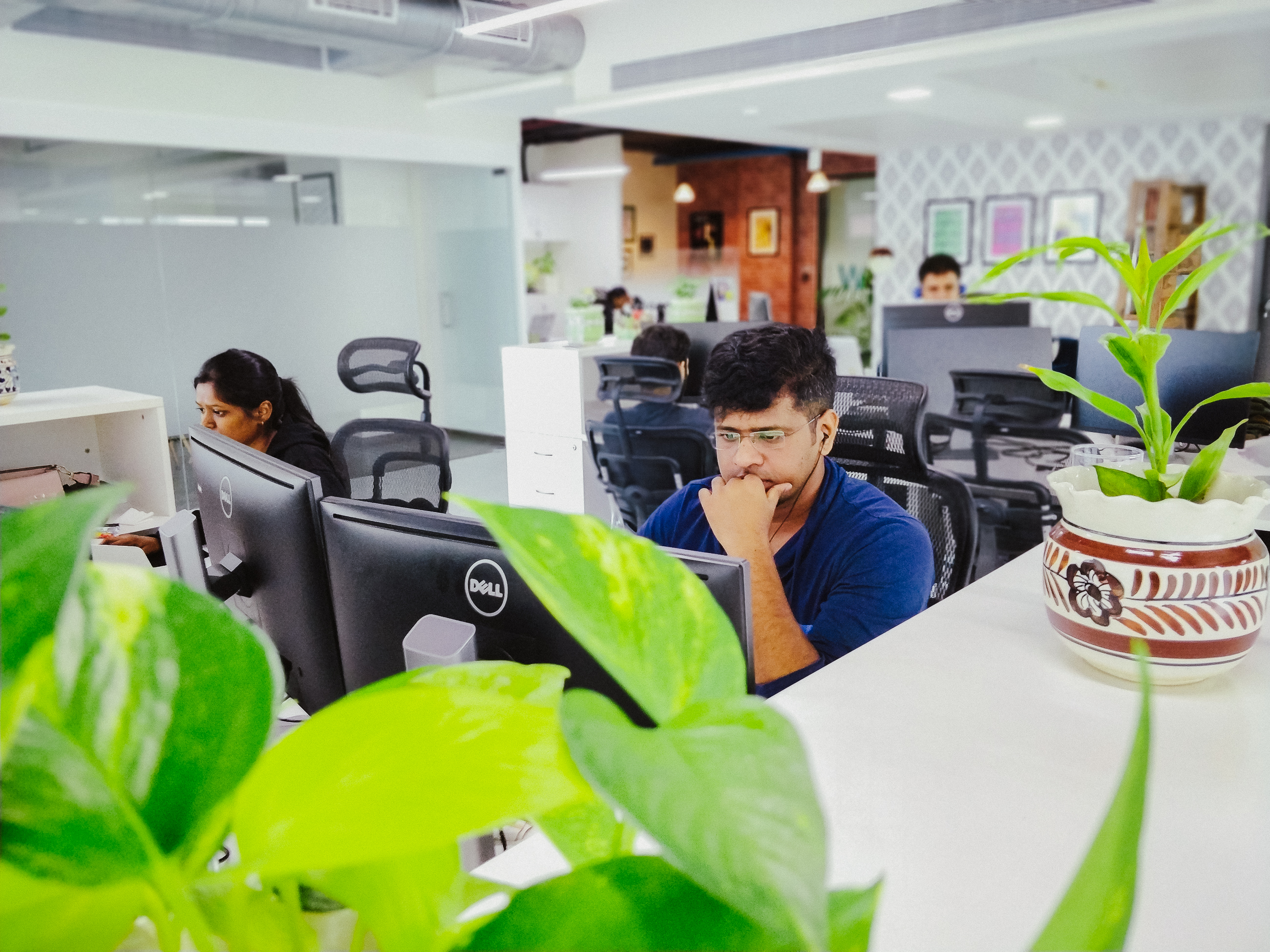 Focused coworkers at their desks in the Mumbai office.