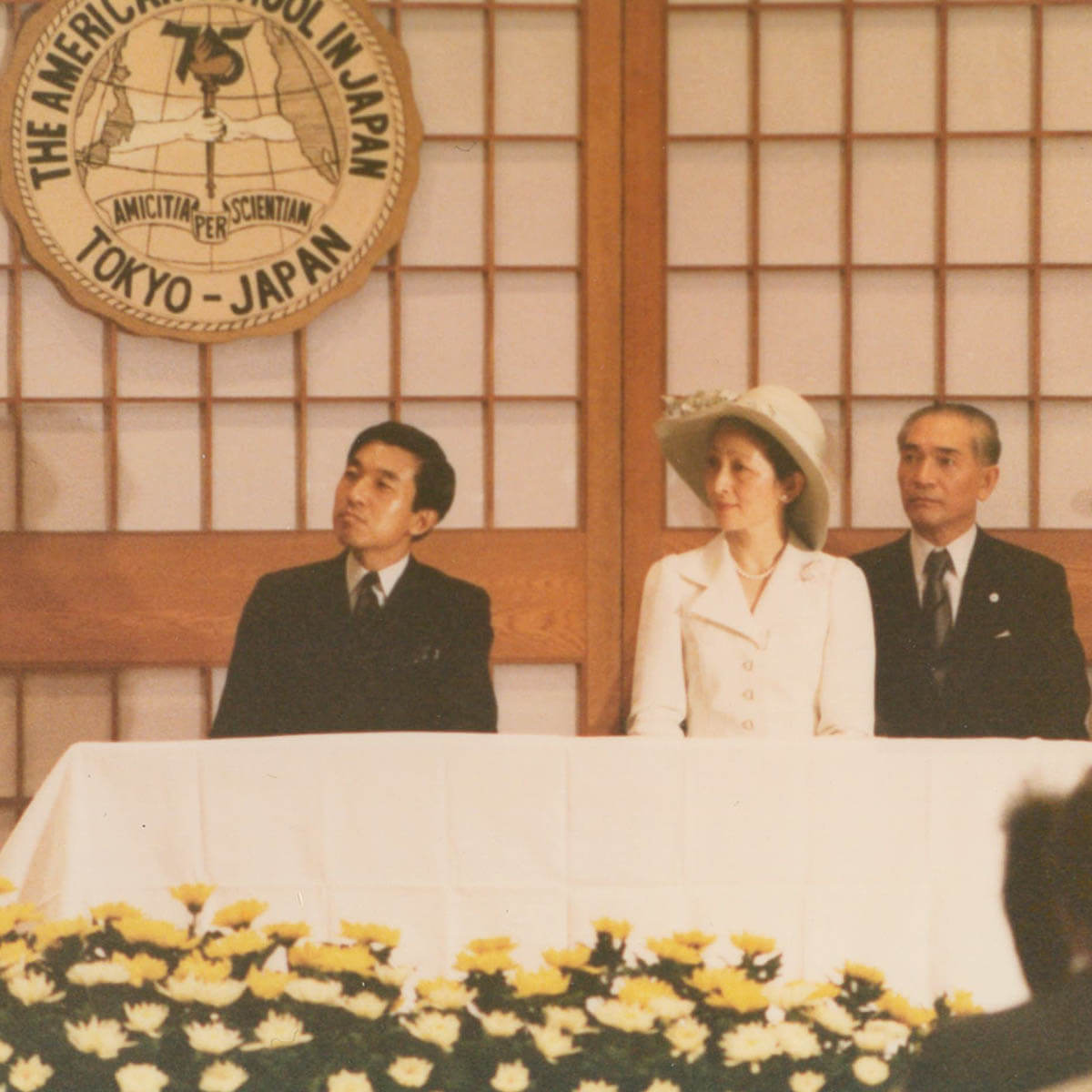 Crown Prince Akihito and His Wife Sit at a Table During ASIJ's 75 Anniversary Celebration