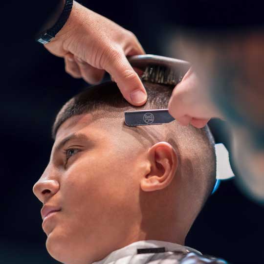Barber using cutthroat razor on skin fade