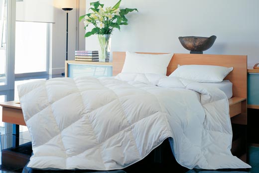 Microcloud bedding down alternative quilt draped over beside
