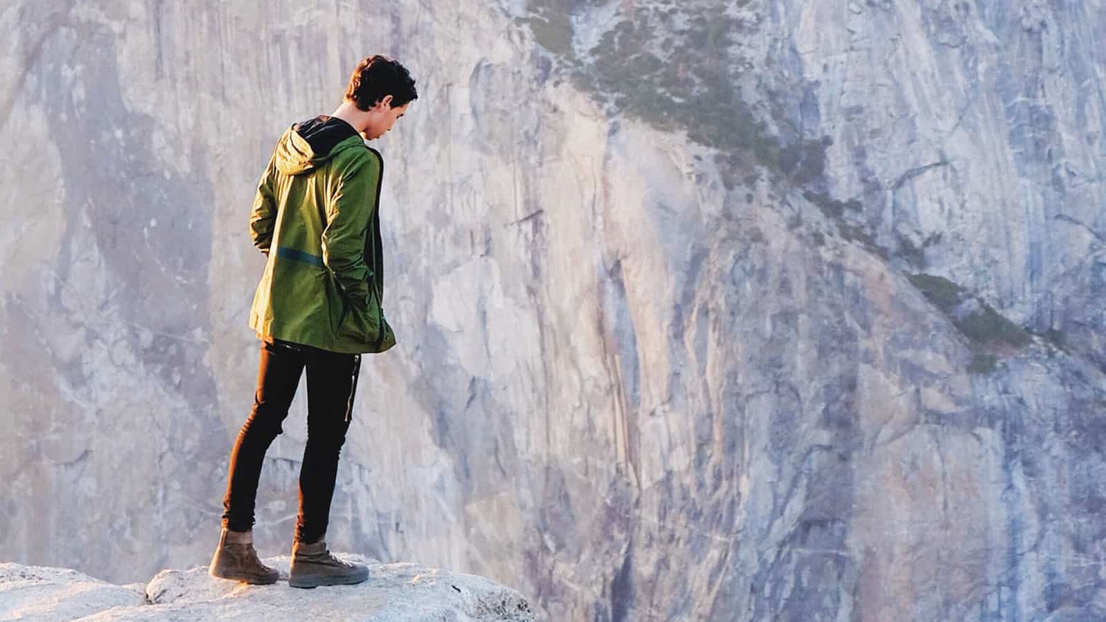Person looking over the edge of a cliff