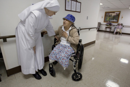 LITTLE SISTER OF THE POOR LISTENS TO CONCERN OF RESIDENT AT HOUSE IN WASHINGTON