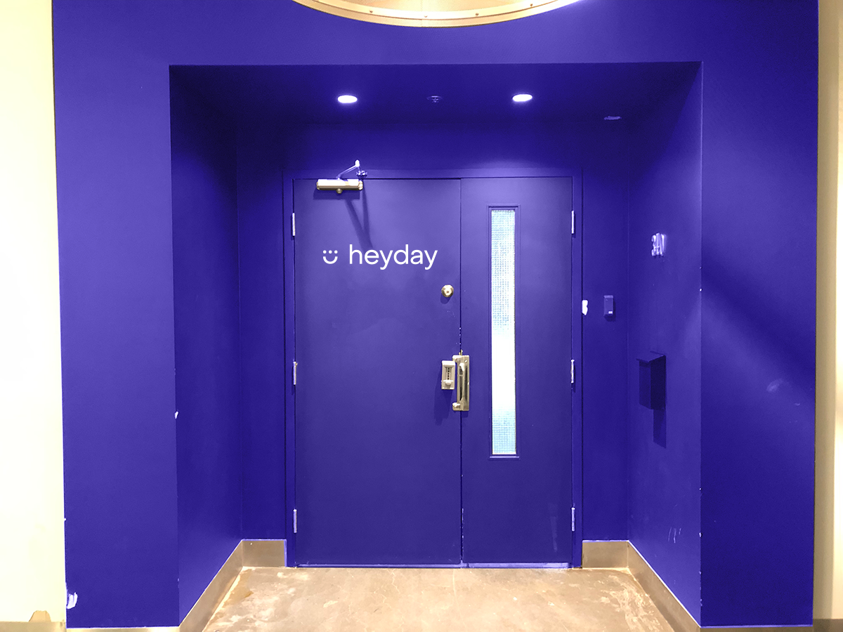 A purple door labeled Heyday with the logo.