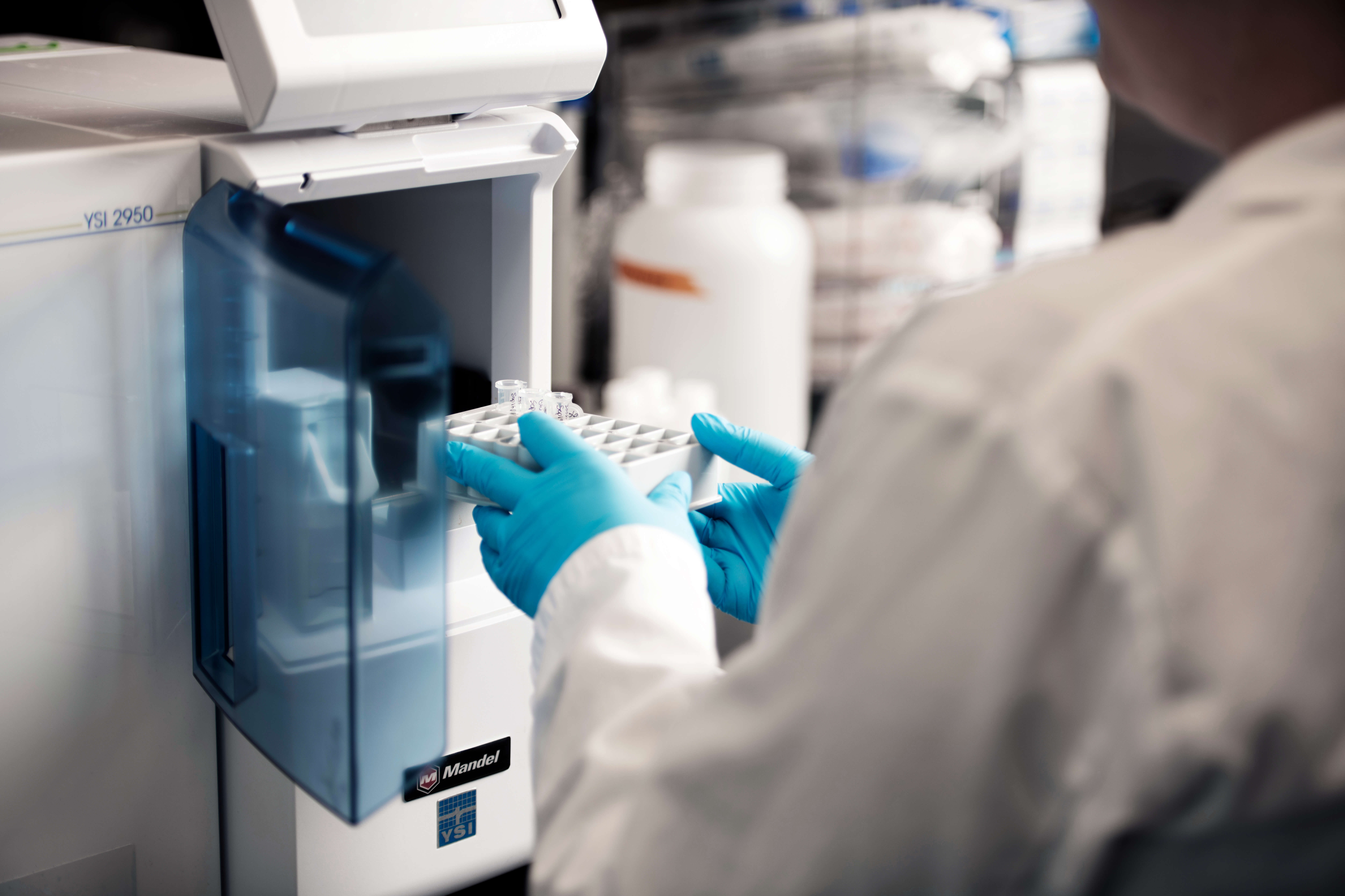 A scientist using a biochemistry analyzer