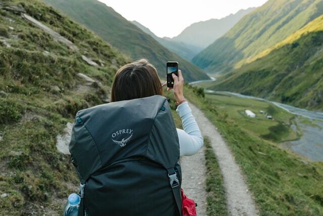 backpacker taking pictures of scenery
