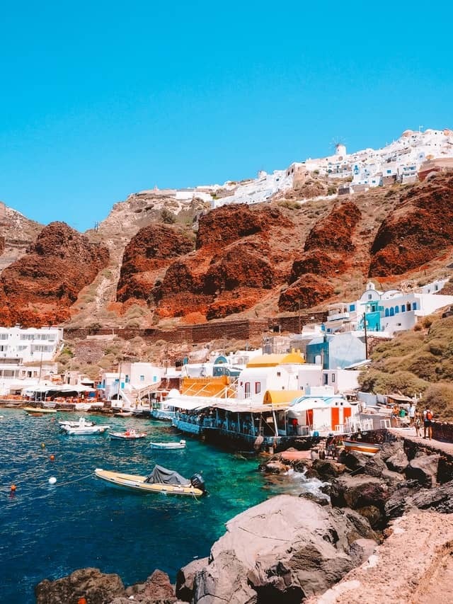 Cove with clear water and boulders in Santorini