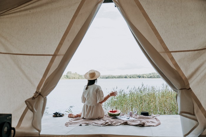 girl relaxing on vacation tent overlooking view
