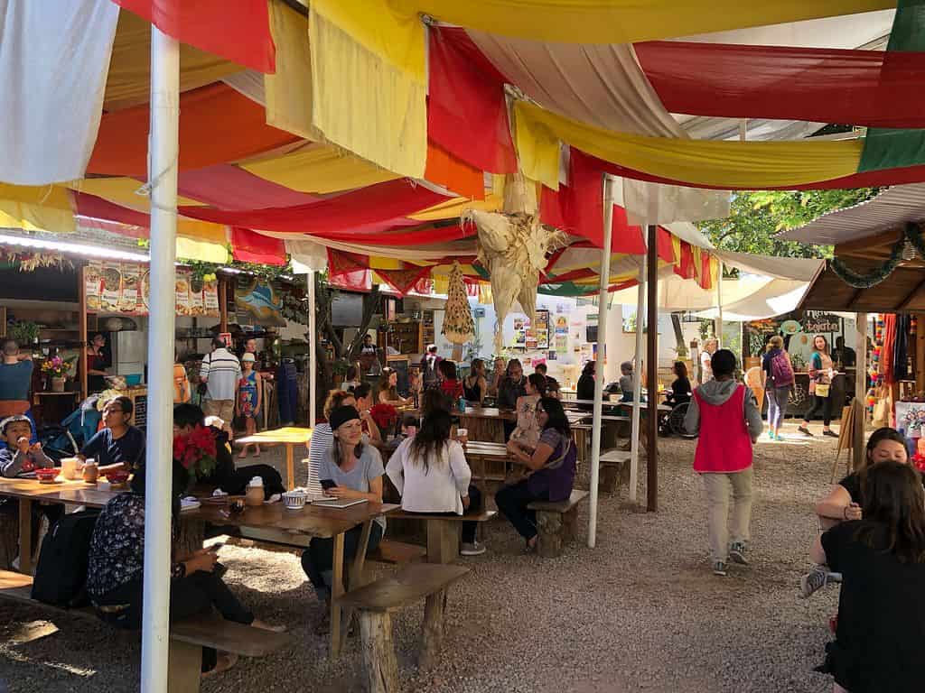 people sitting in mercado benito juarez restaurant in oaxaca