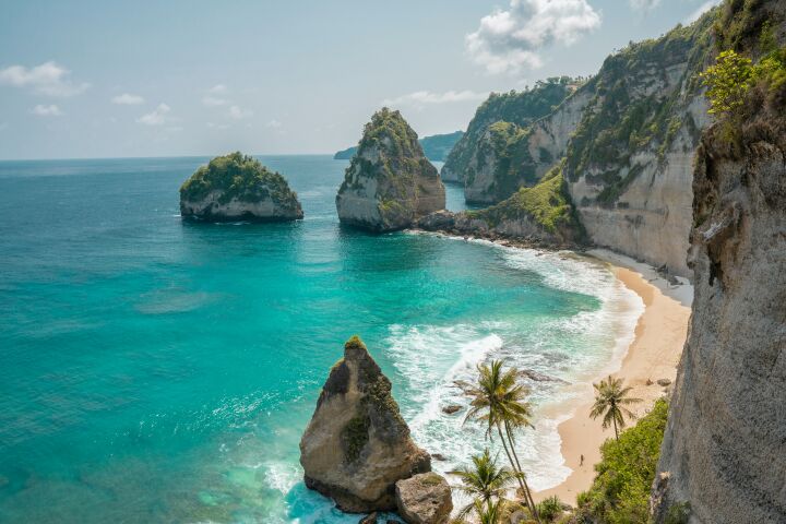 Cliffs by sandy beach in Bali