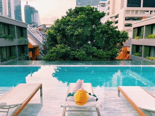 Woman relaxing by poolside in Bangkok