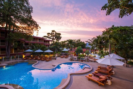 Poolside at the Chanalai Flora Resort at sunset