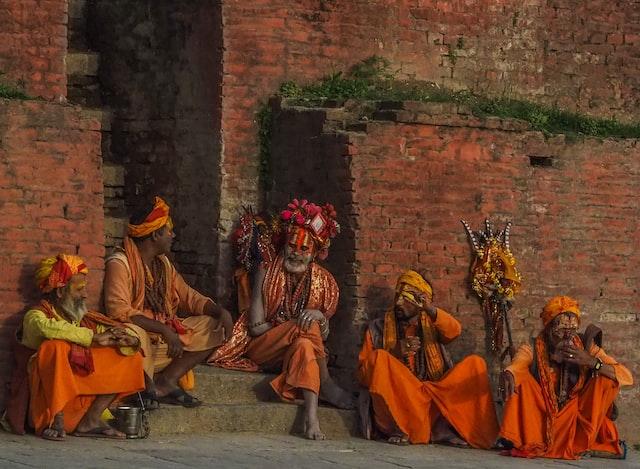 religious monks sitting outside walls in Nepal