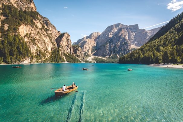 people rowing a boat in clear