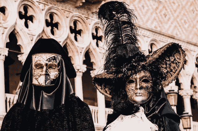 two people in costumes at the carnival of venice