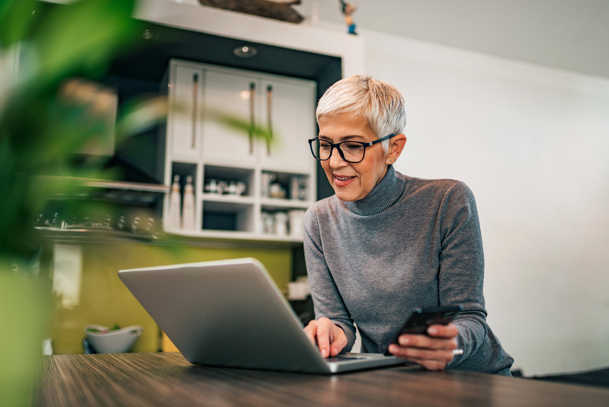 Older woman using laptop. Credit: iStock.com/nortonrsx