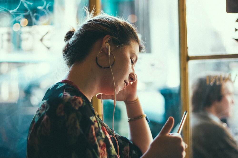 a woman listening to HR podcast