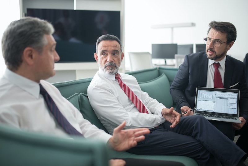 Three managers talking on a couch
