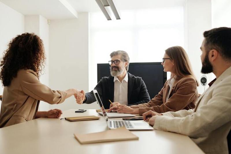 A recruiting team welcoming a new candidate to the organization