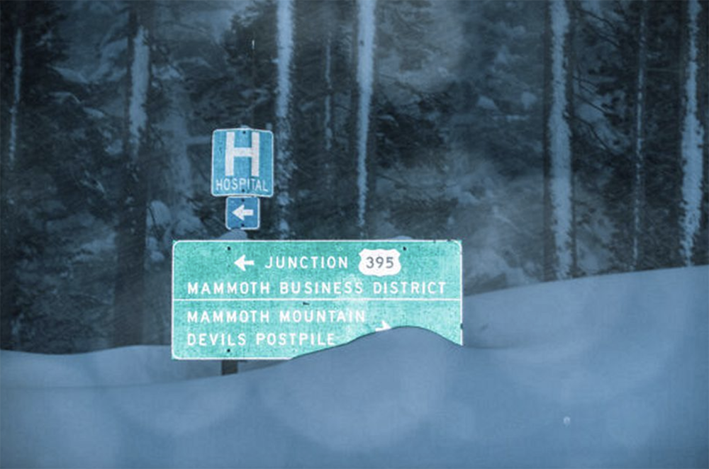 Mammoth street sign covered in snow