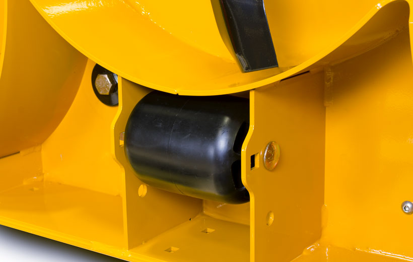 Image of the underside of a yellow mower deck with a black wheel mounted between plates of steel