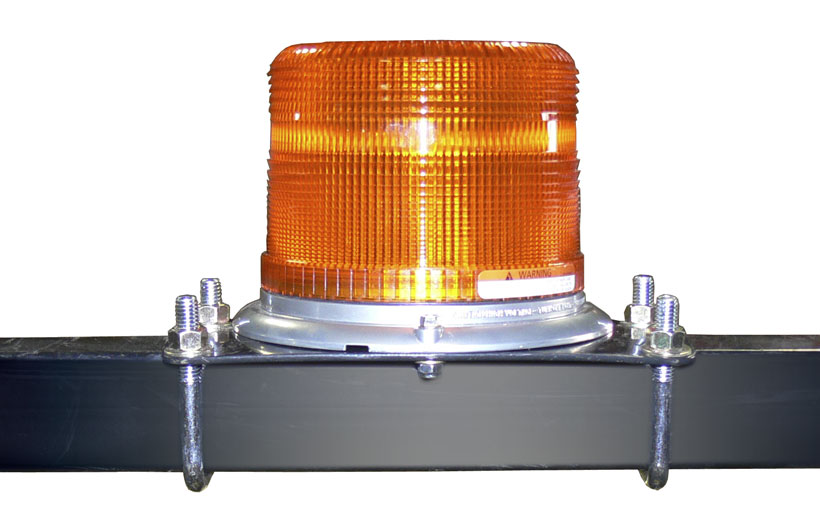Image of an orange light mounted on a black roll over bar of a mower.