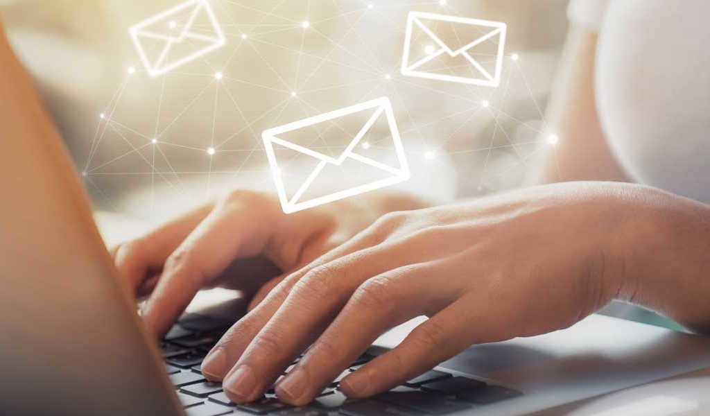 Person looking emails containing email attacks on her laptop