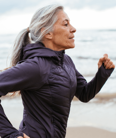 Mature woman running on the beach