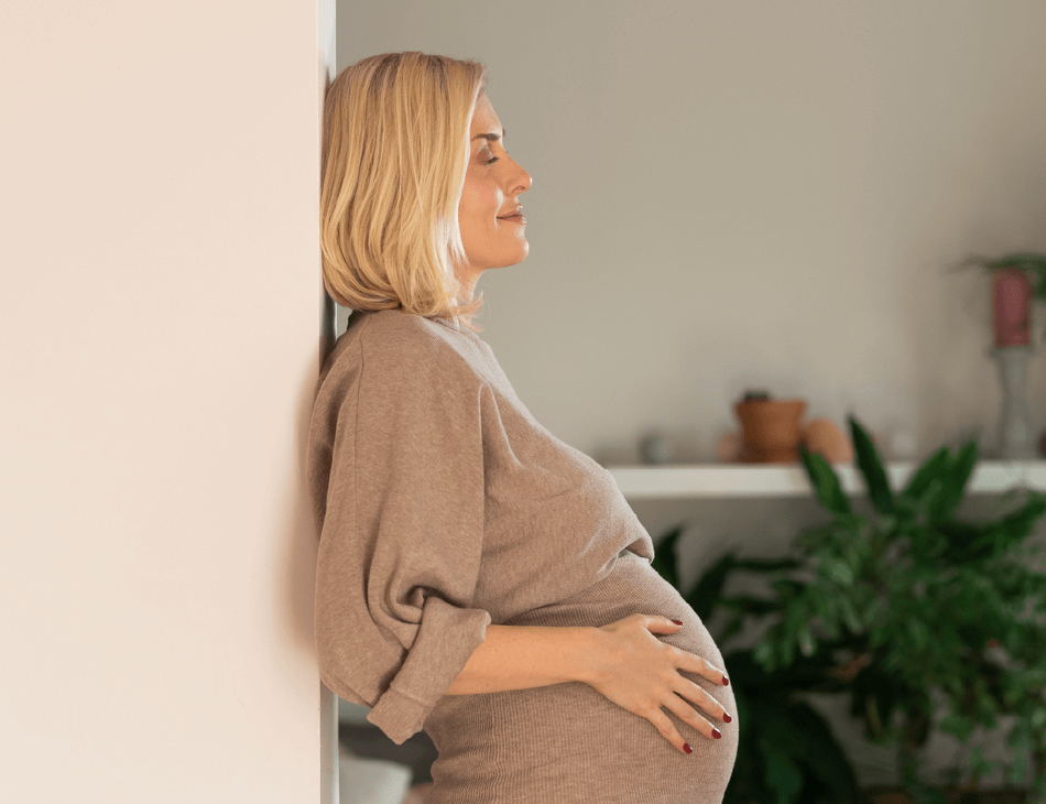 Pregnant woman holding belly
