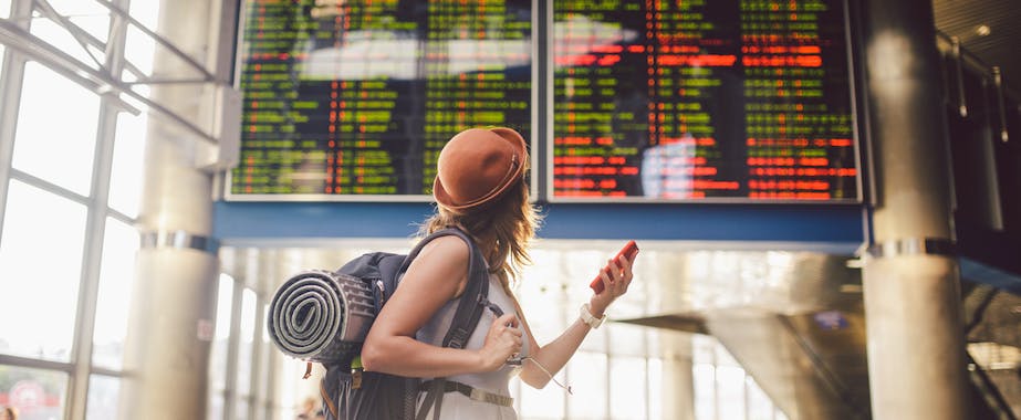 Backpacker checking flight schedules in airport