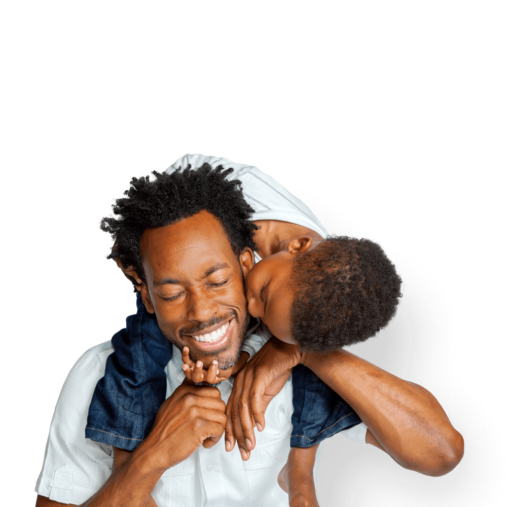 A smiling father playing with his son.