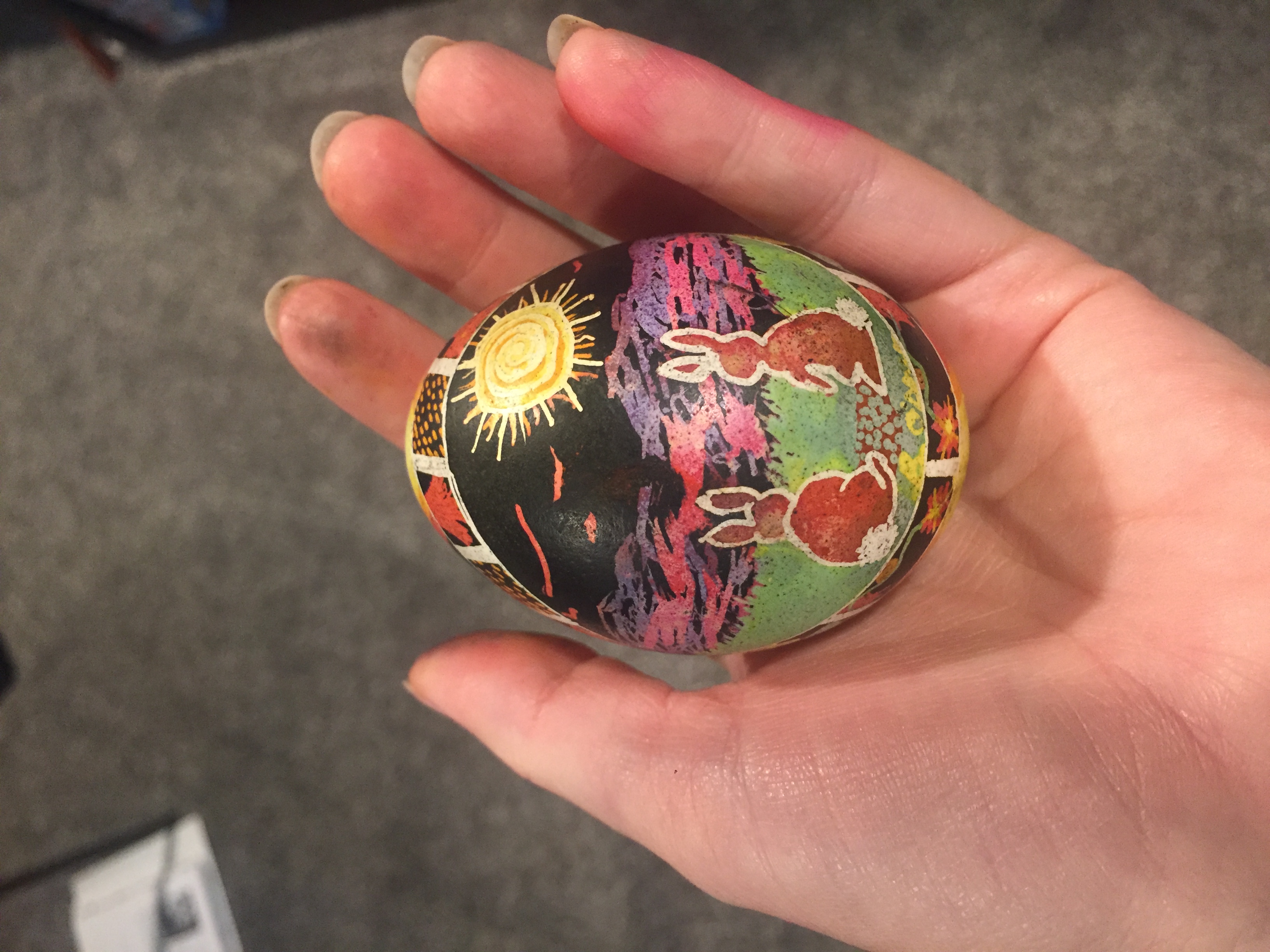 A single completed egg picturing two rabbits gazing at a sunset