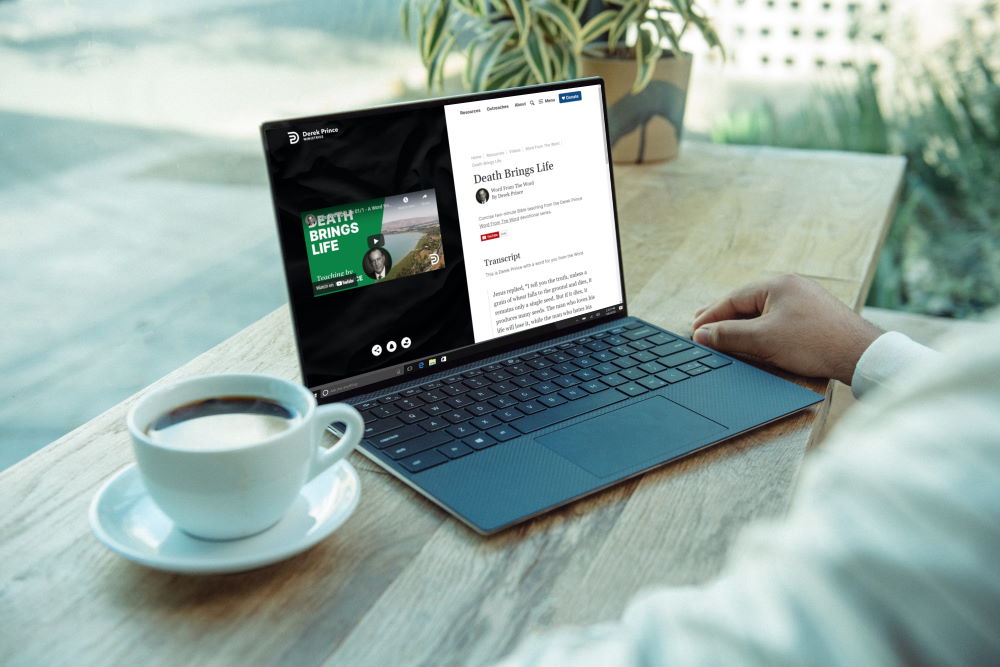A man watching a Word From The Word video on his laptop with a cup of coffee