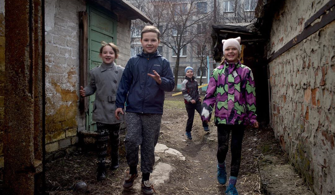 Four happy kids jumping and laughing