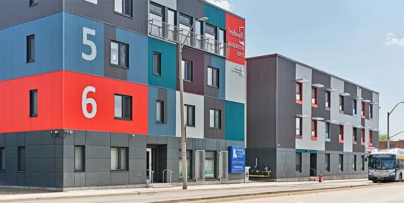 A colorful building that is part library and part apartment complex
