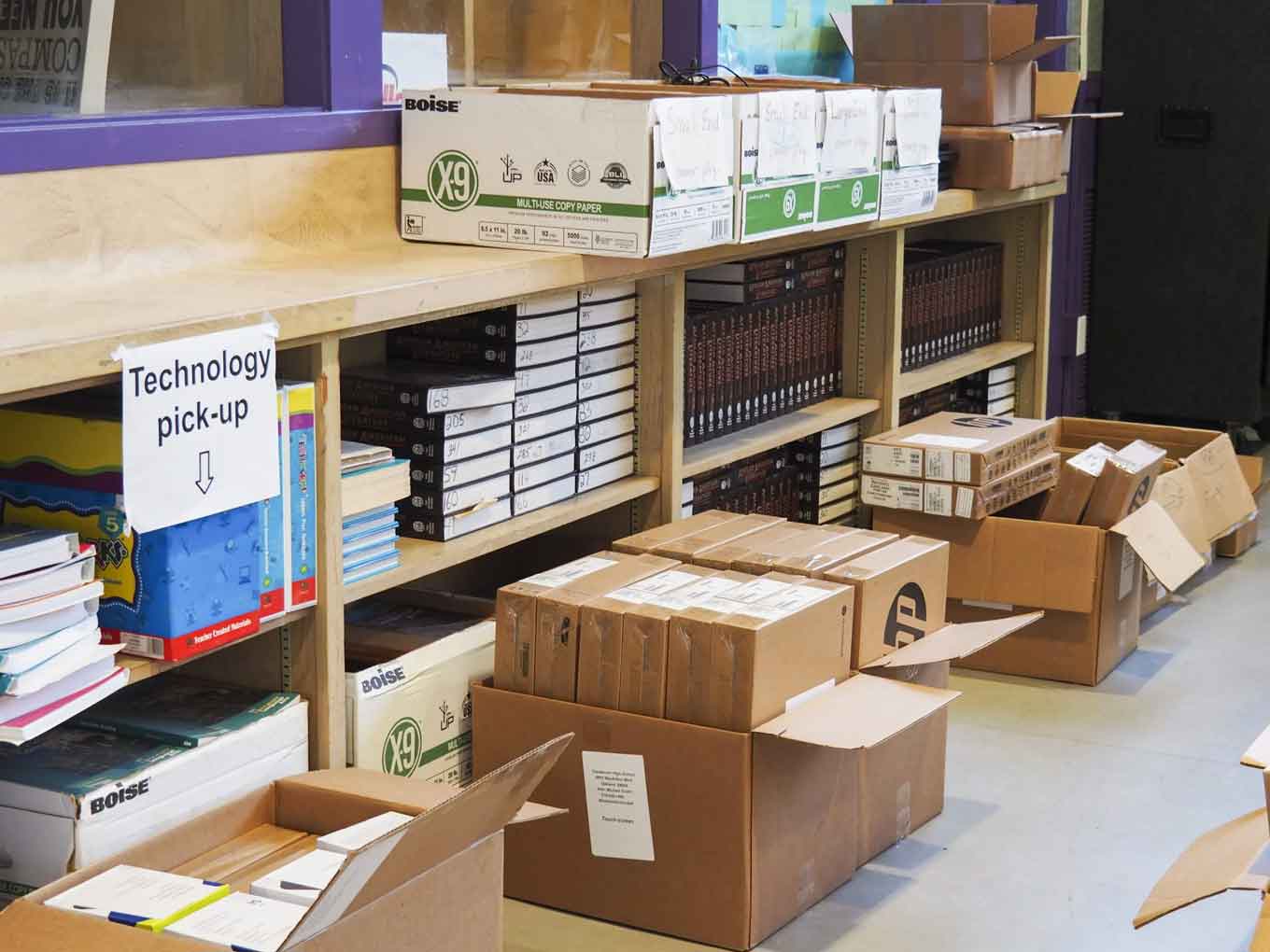 Boxes of #OaklandUndivided devices wait for student pickup at Castlemont High School in May 2021.
