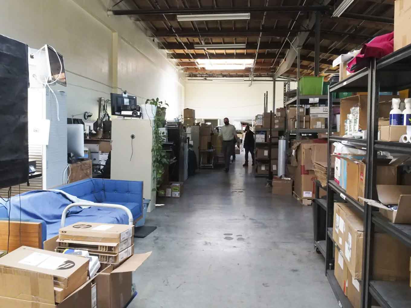 Seth Hubbert, then Tech Exchange’s executive director, walks through the nonprofit’s warehouse in May 2021. This is where #OaklandUndivided devices were delivered and sorted before being distributed to students.