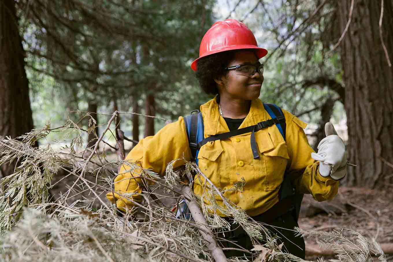 One of the firefighters smiles while doing a hand sign