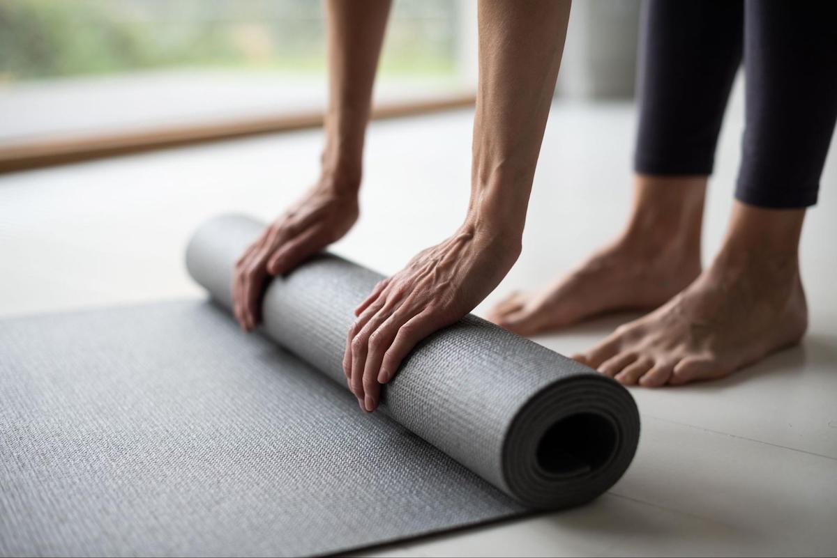 Normal blood sugar levels: A closeup of two hands unrolling a yoga mat