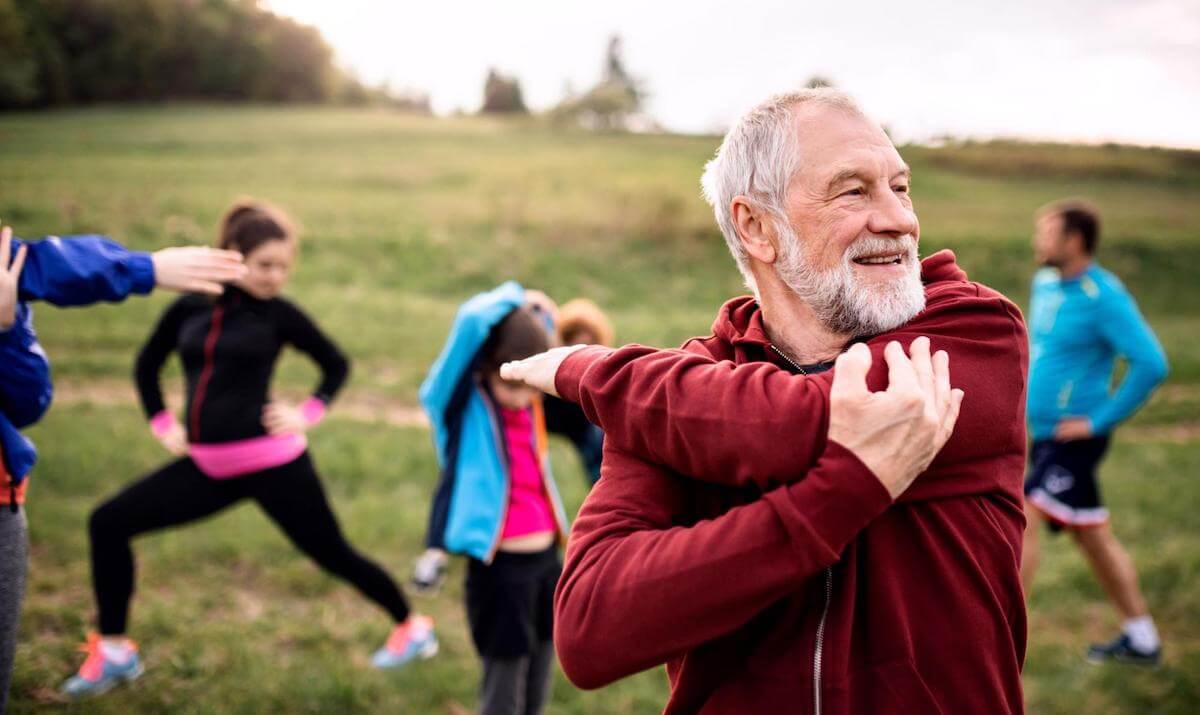 Fasting blood sugar levels: A man stretches outdoors with a group