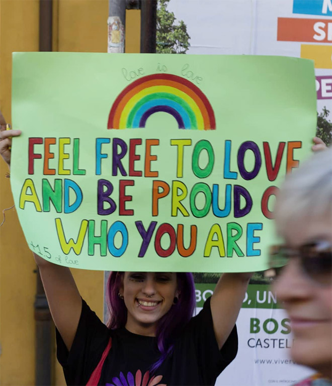 sign that reads feel free to love and be proud of who you are