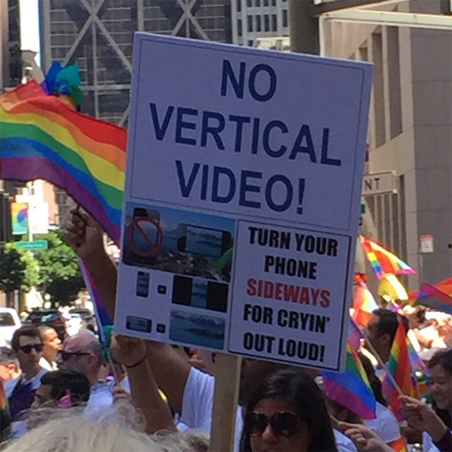 sign that reads no vertical video at a gay pride parade