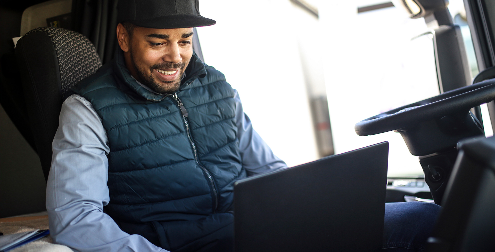 trucker booking loads on laptop