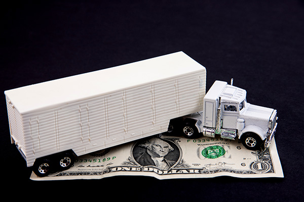 trucker shaking hands with insurance company agent