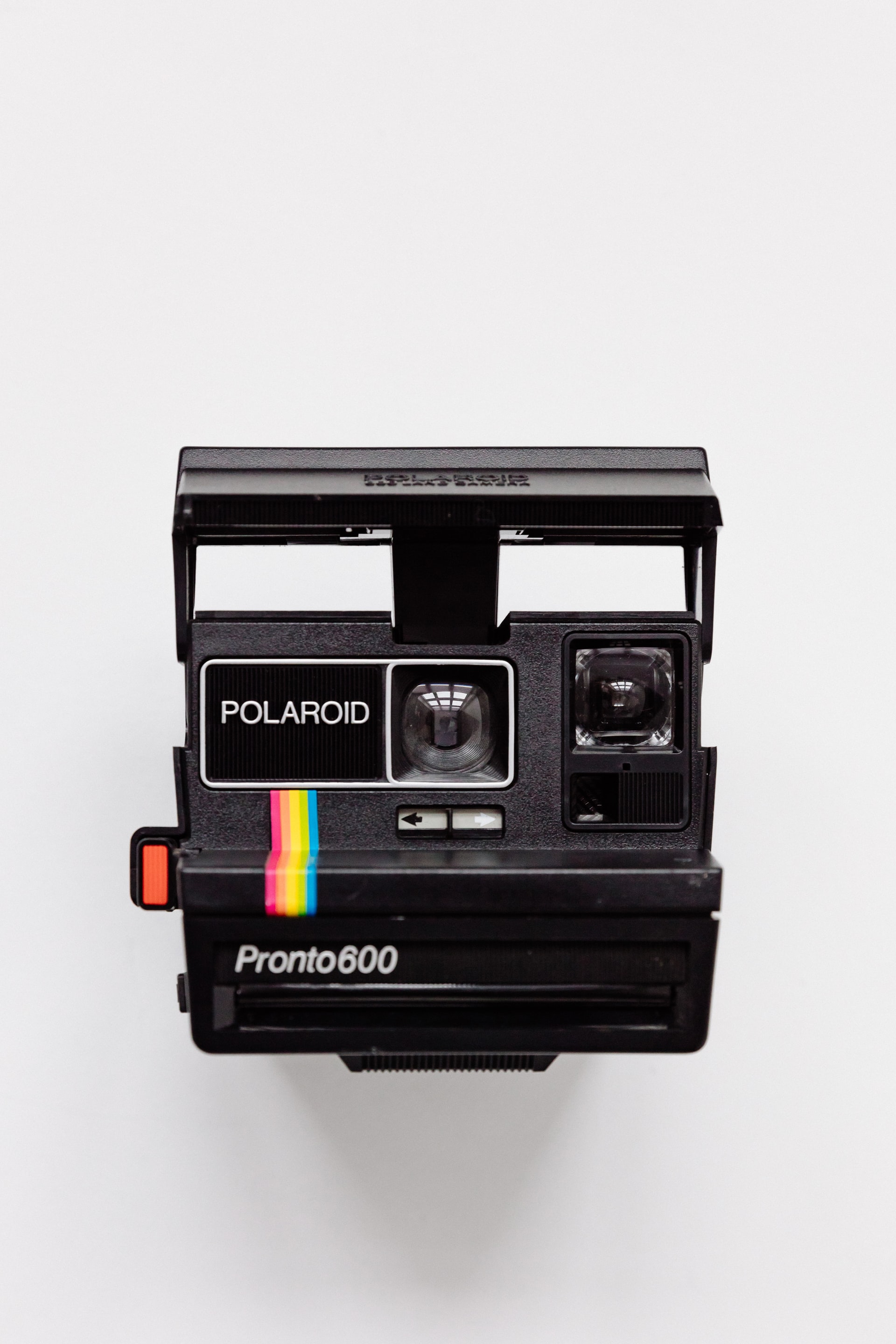 An image of a polaroid camera on a white backdrop